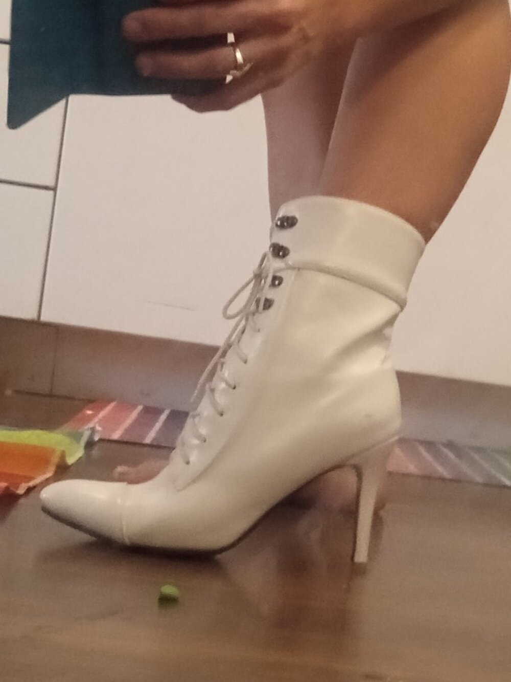 White faux leather lace-up heeled boots.